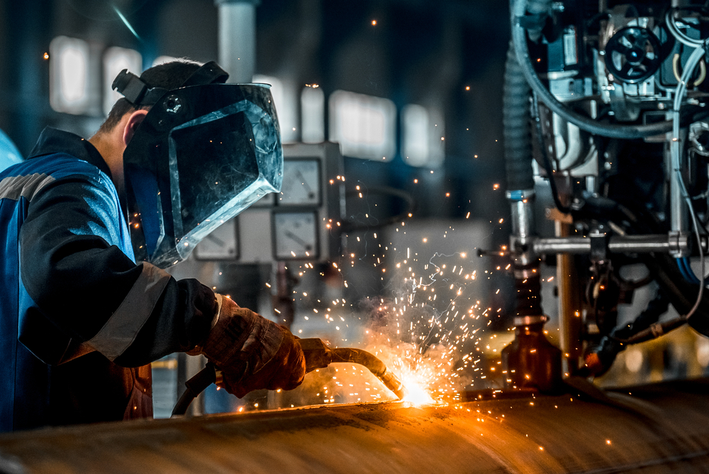 stock-photo-man-welds-at-the-factory-539932924
