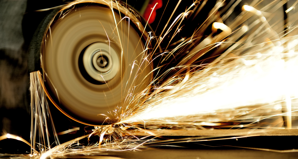 stock-photo-worker-cutting-metal-with-grinder-sparks-while-grinding-iron-197433428